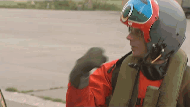 a man wearing a helmet and goggles with the letter m on it