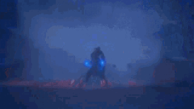 a man with a beard is holding a candle and a blue light coming out of his eyes .