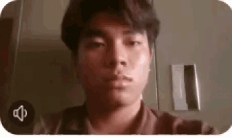a young man is taking a selfie in front of a camera .