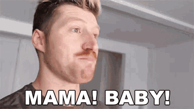 a man with a beard is making a funny face and saying mama baby .
