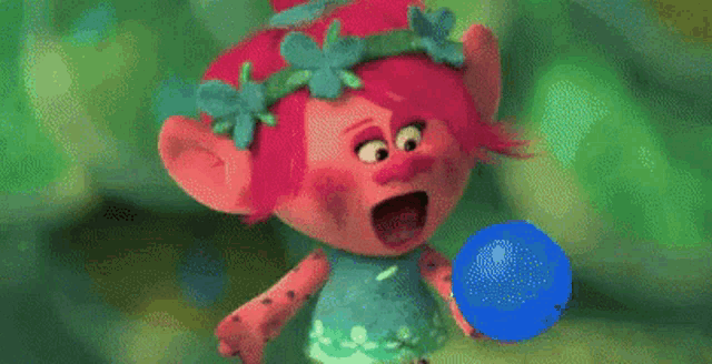 a troll from the movie trolls is standing in a pile of plants .