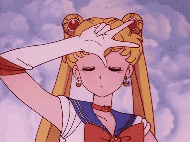 a girl in a sailor suit is making a peace sign with her finger