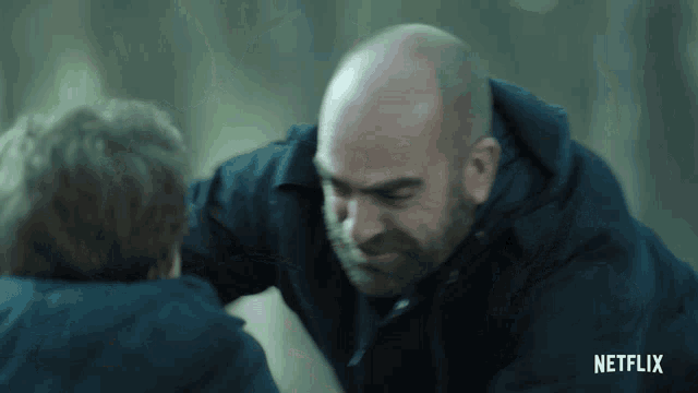 a man with a beard is talking to another man with a netflix logo on the bottom