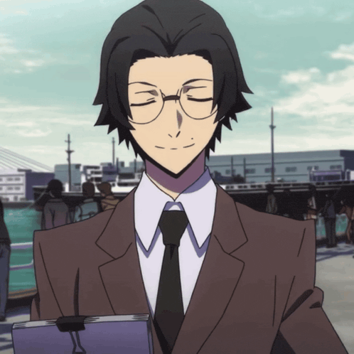 a man in a suit and tie is holding a book