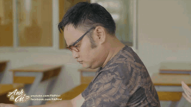 a man wearing glasses is making a funny face and says gi