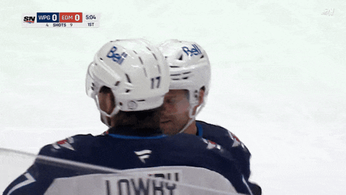 a hockey player wearing a helmet that says bell
