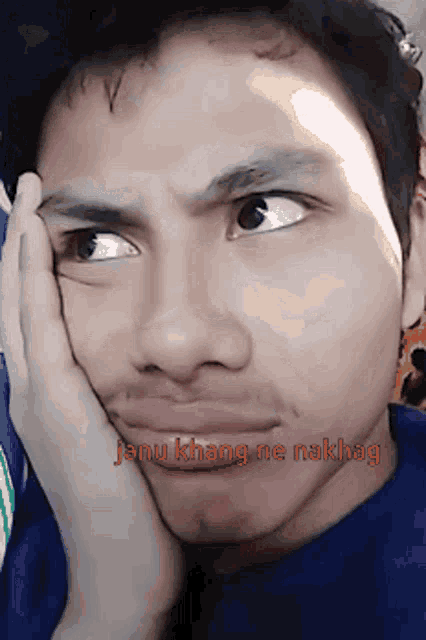 a close up of a man 's face with the words janu khang ne nakhag above it