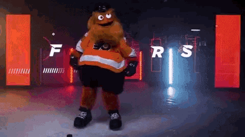 a mascot for the flyers is standing on a ice rink
