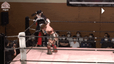 two women are wrestling in a ring with #tjpw on the bottom