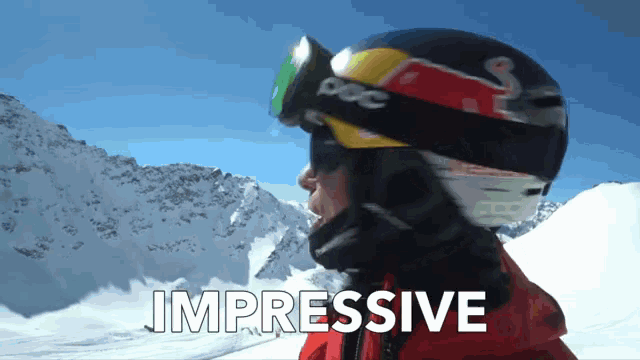 a person wearing a red bull helmet and goggles with the words impressive below them