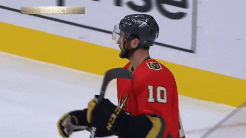 a hockey player wearing a red jersey with the number 10 on it