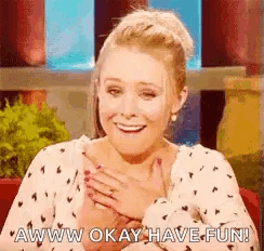 a woman is smiling with her hands on her chest and says aww okay have fun .