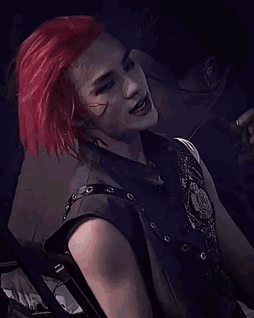 a blurry picture of a person with red hair and a skull