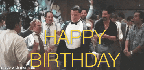 a man in a tuxedo is dancing in front of a crowd with the words happy birthday written on the bottom