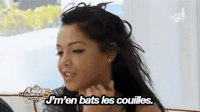 a woman is sitting on a couch with the words j 'm 'en bats les couilles .