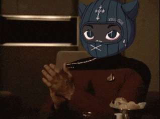 a man wearing a mask that says x on it is clapping his hands