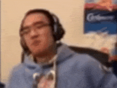 a blurry picture of a man wearing headphones and a hoodie .