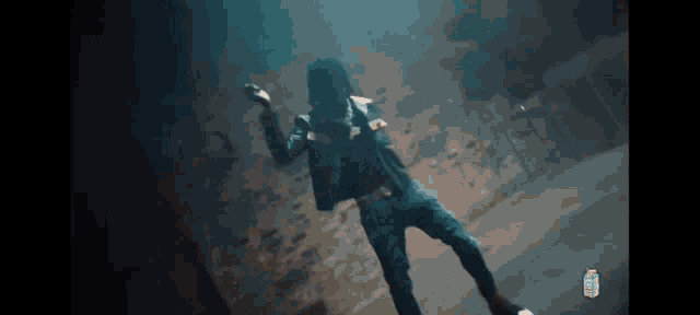 a man is dancing in a dark room with a bottle of diet coke in the background