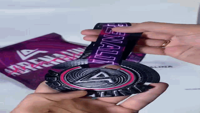 a person is holding a medal that has the word penalty on it