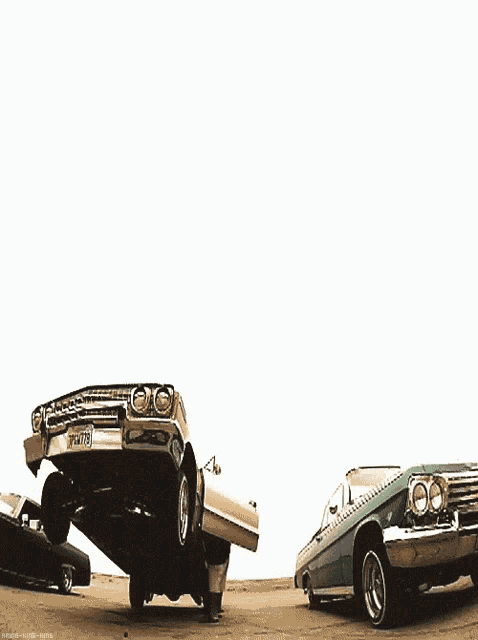 a white car with a license plate that says yfm675 is parked next to a green car