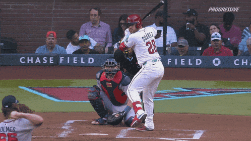 a baseball player with the number 28 on his jersey is at bat