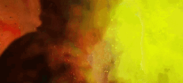 a close up of a yellow and red smoke coming out of a hole in a wall .