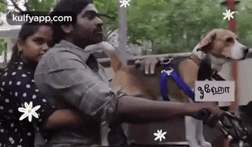 a man and a woman are riding a motorcycle with a dog in a cart .
