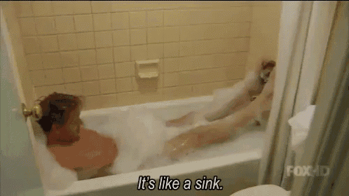 a man is taking a bath with the words it 's like a sink behind him