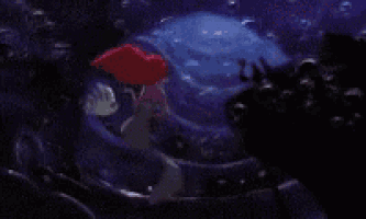 ariel from the little mermaid is swimming in a pool of water .