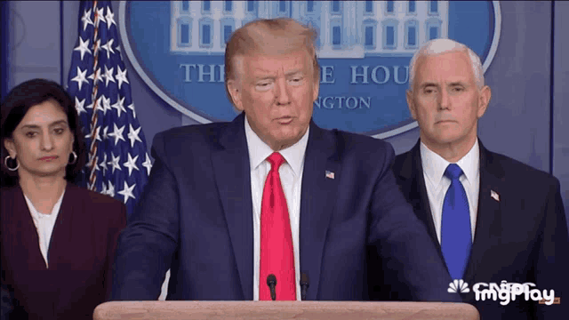 a man in a suit and tie stands at a podium in front of the white house
