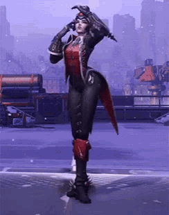 a woman in a black and red outfit is standing on a snowy surface .