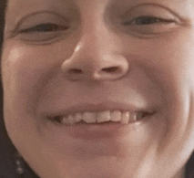 a close up of a woman 's face smiling