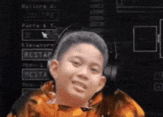 a young boy wearing headphones is smiling in front of a computer screen that says online