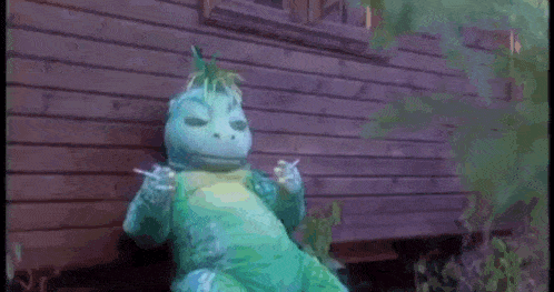 a stuffed animal is holding two cigarettes in its hand