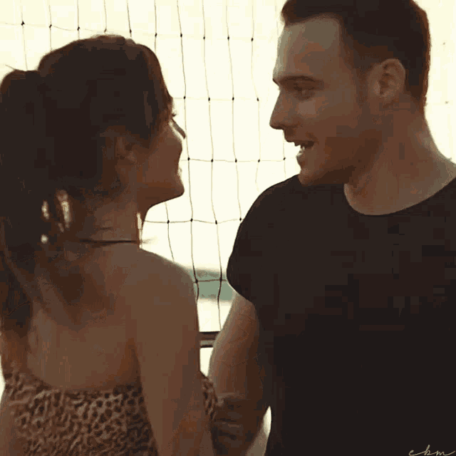 a man and woman are looking into each other 's eyes