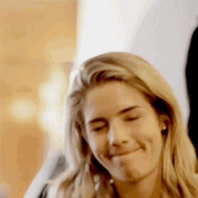 a close up of a woman making a funny face