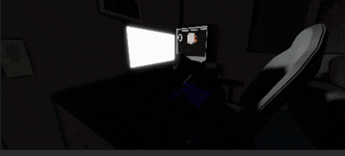 a dark room with a chair and a computer