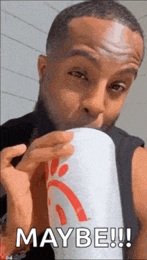 a man is drinking from a chick-fil-a cup and saying maybe .