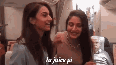 two women are sitting next to each other on an airplane and the words tu juice pi are on the bottom