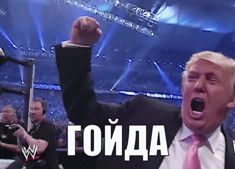 a man in a suit and tie is raising his fist in the air and screaming in russian .