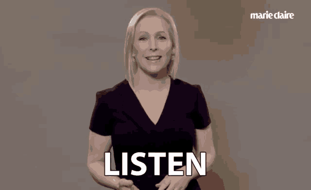 a woman in a black dress is saying listen