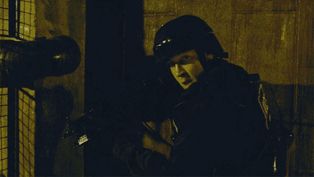 a man wearing a helmet has a sticker on his jacket that says ' a.m.p. ' on it