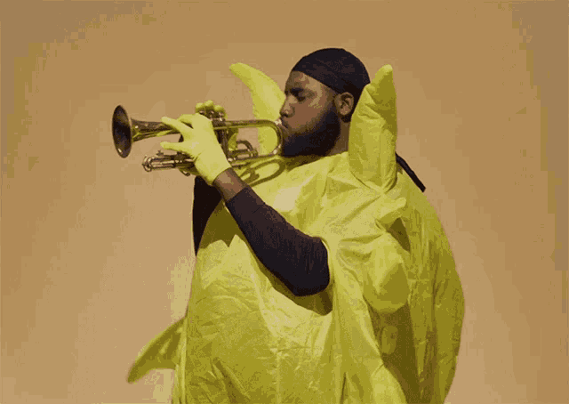 a man playing a trumpet in a yellow outfit