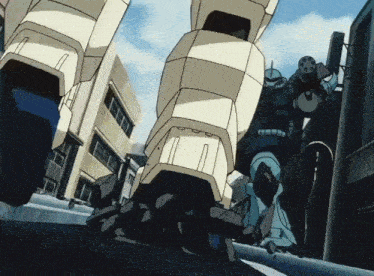 a robot is walking down a street in front of a building