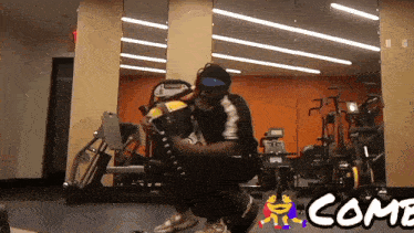 a man squatting down in a gym with the word come written on the bottom