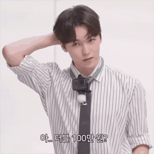 a man wearing a striped shirt and tie is talking in korean
