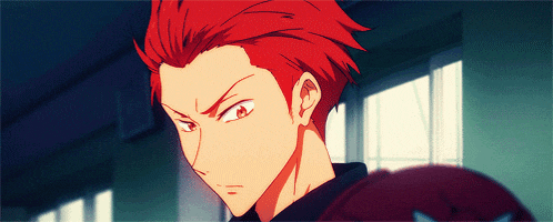 a close up of a person with red hair and a black shirt
