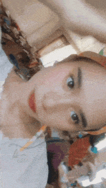 a woman wearing a hat is taking a selfie