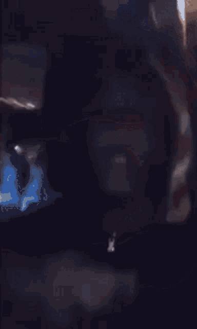a close up of a person 's face with a black background .
