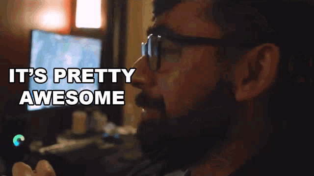 a man with glasses and a beard is saying it 's pretty awesome